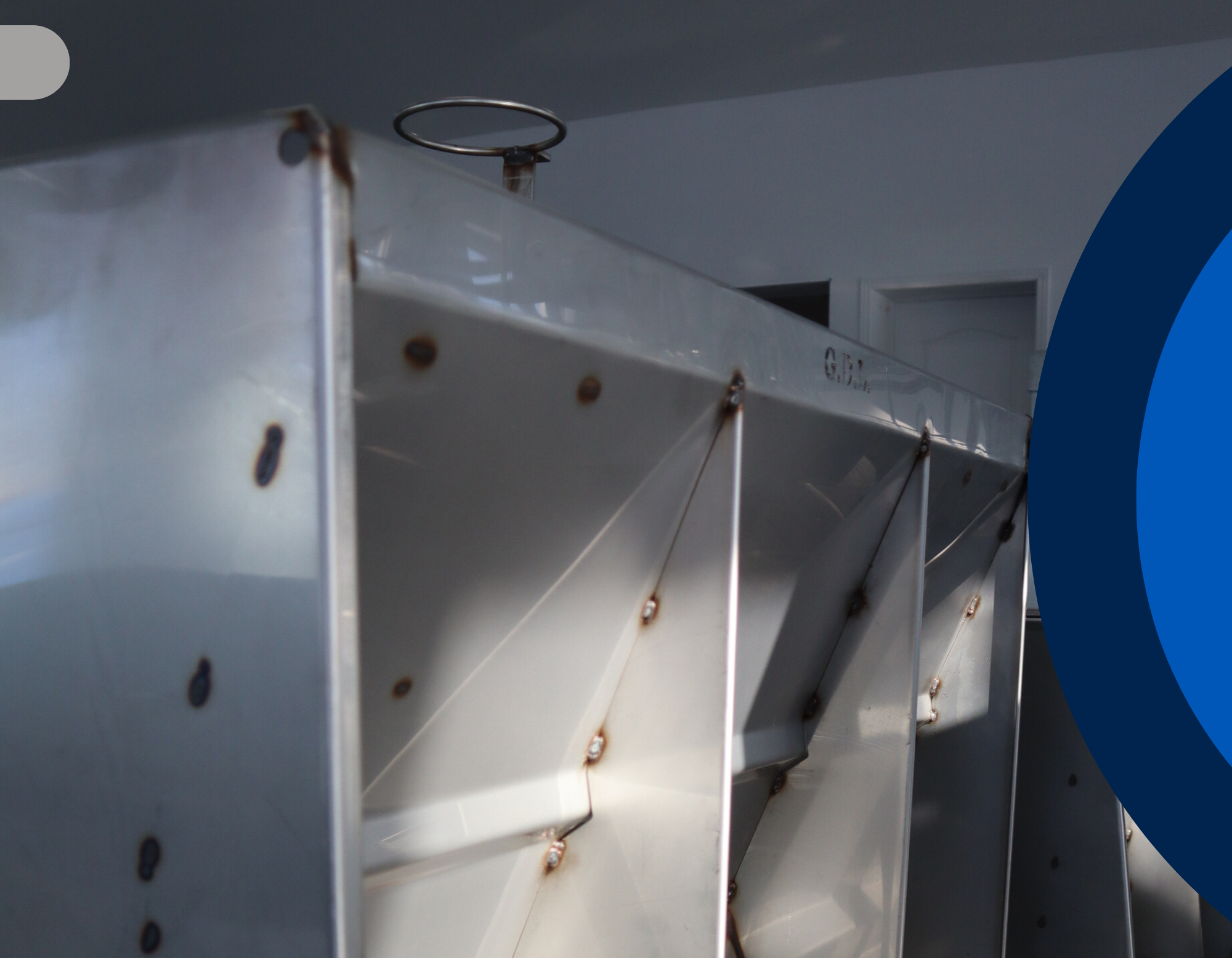 Metallic structure with rust and wear, possibly part of a larger mechanical or industrial component made by GDL Equipments